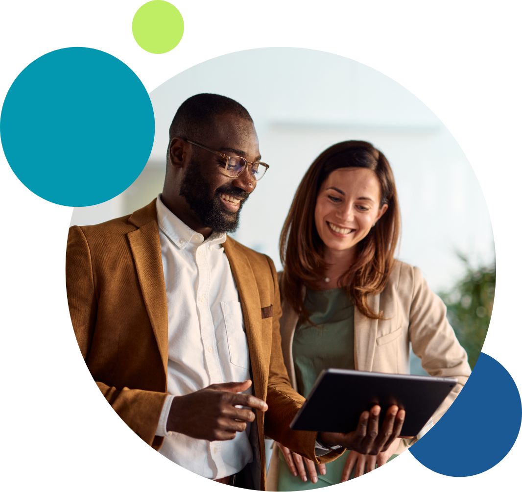 A man and woman look over a tablet